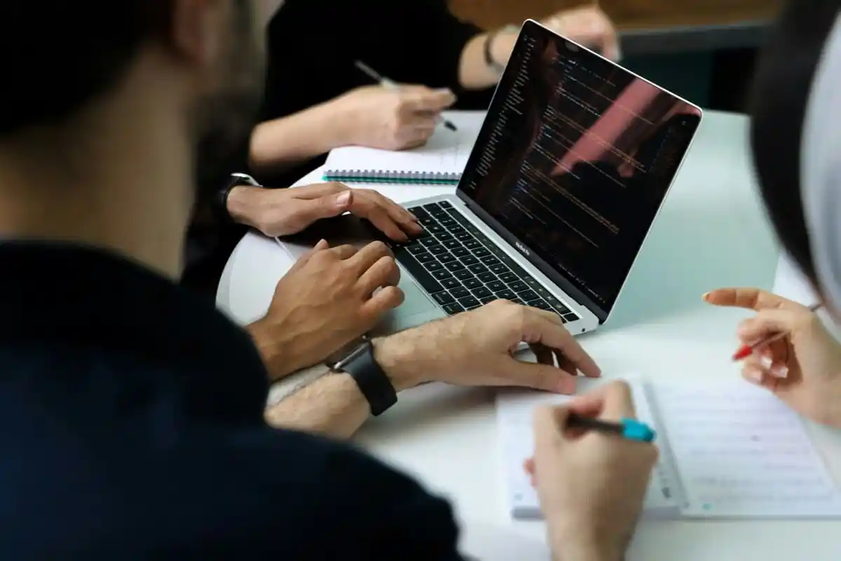 Team members working through a website build together at a table