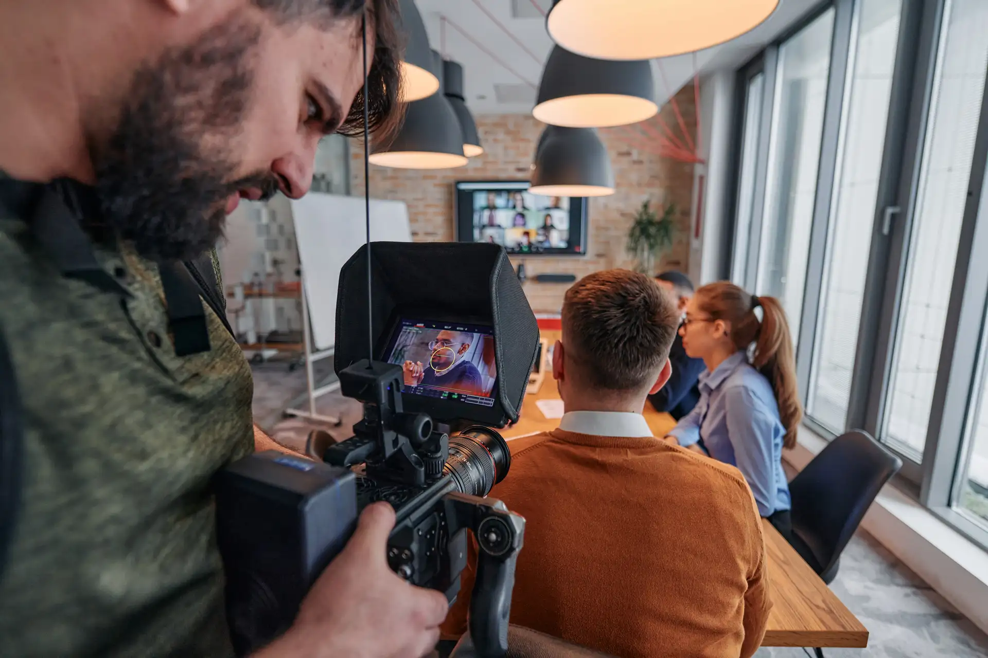 Videographer capturing corporate dynamics on set while filming a business video marketing production