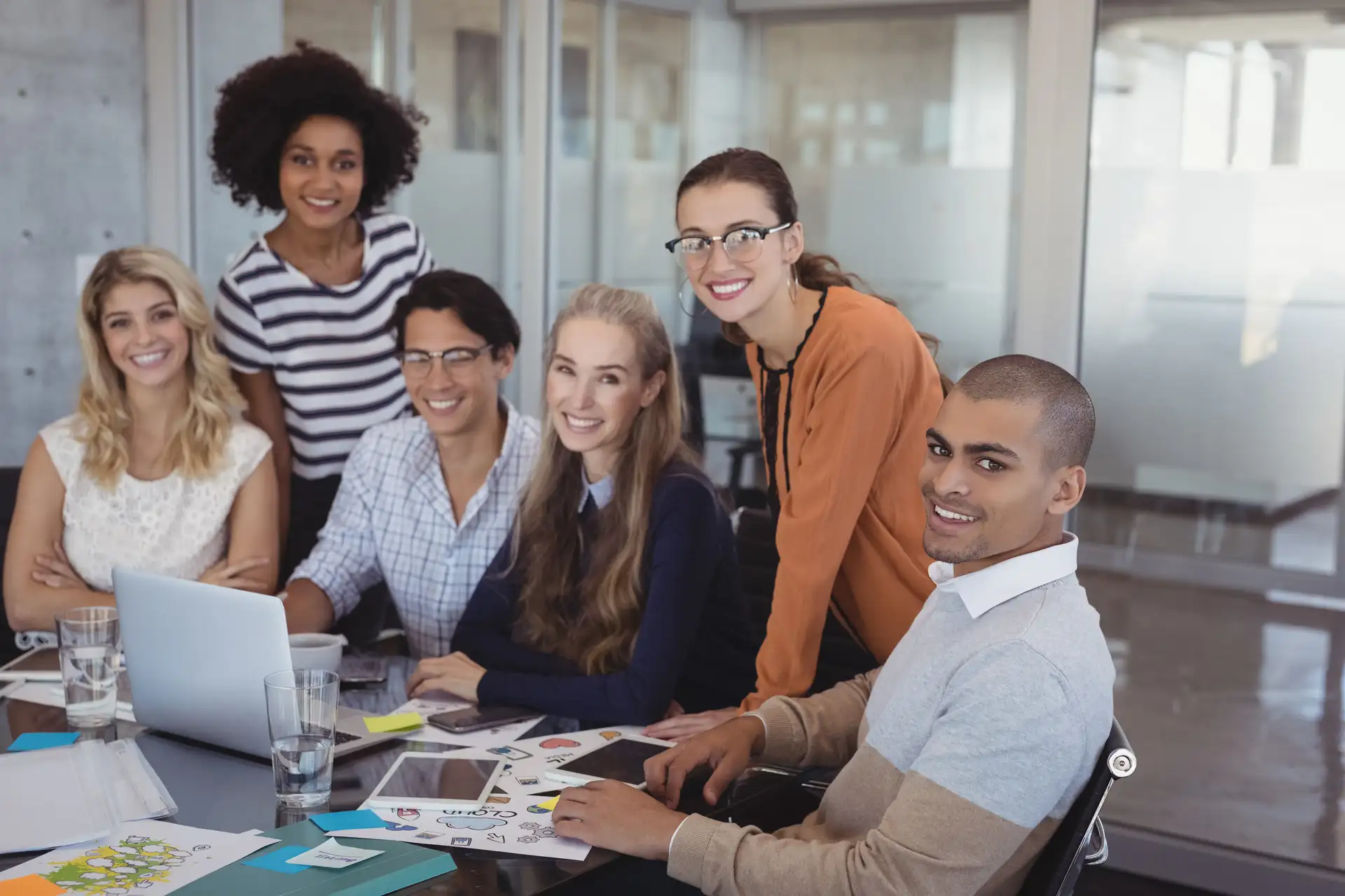 Smiling colleagues planning B2B marketing strategy together in a creative office setting